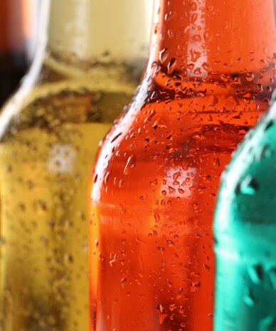 Close-up view of colorful beer bottles with condensation | © Markus Mainka