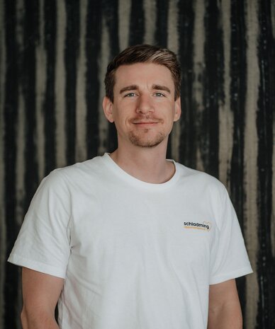 Portrait of a man in white T-shirt with Schladming logo