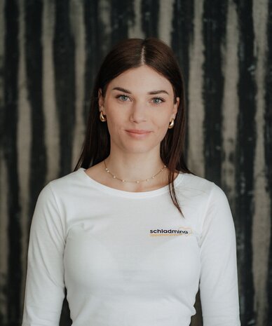 Portrait of a woman indoors in white logo shirt