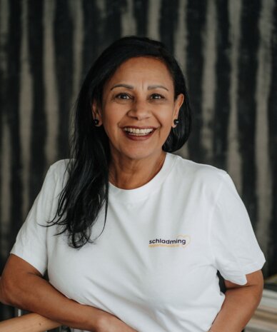 Smiling woman wearing white t-shirt with Schladming logo