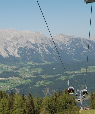 Cable car with Reiteralm sign over alpine valley