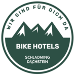 Circular badge showing mountain silhouette and Schladming Dachstein Bike Hotels