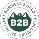 Round seal featuring mountain silhouettes and B2B letters