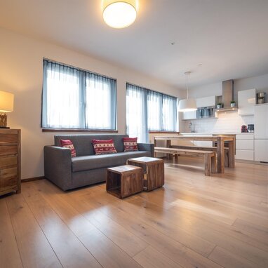 Open living area with sofa, dining table and wooden furniture