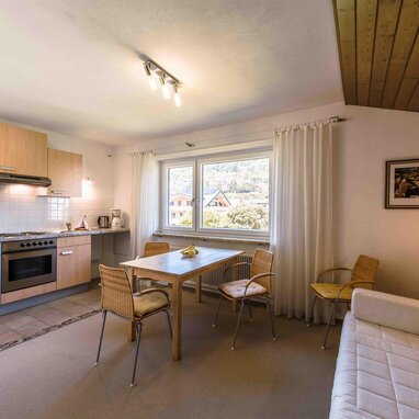 Kitchen and dining area with wooden ceiling and window