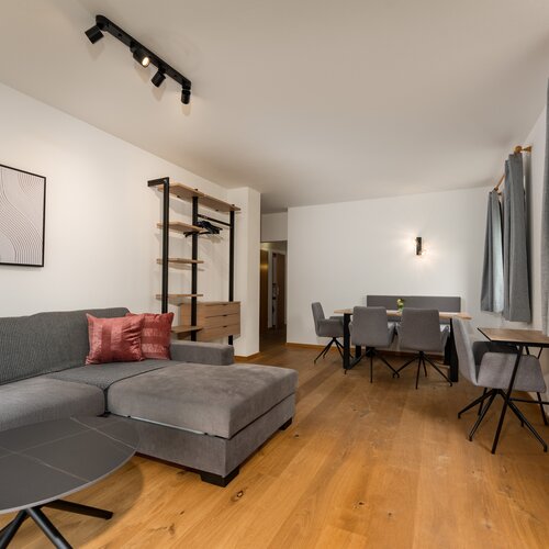 Gray sectional sofa with pink cushions in living area