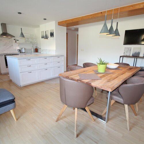 Open-plan kitchen and dining area with white island