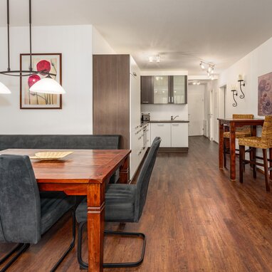 Open-plan dining area with wooden table and gray chairs