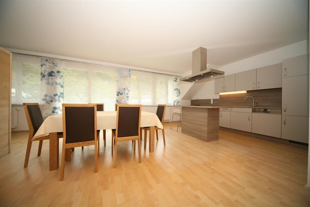 Spacious modern kitchen with island and dining table