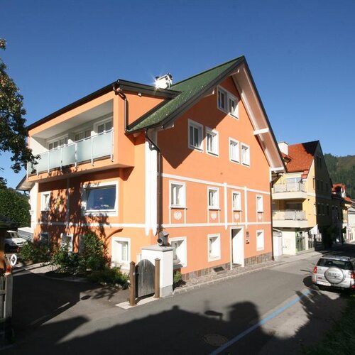 Orange apartment building on a sunny street in town