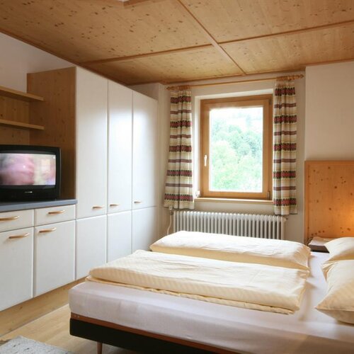 Cozy hotel room with twin beds, wardrobe, window