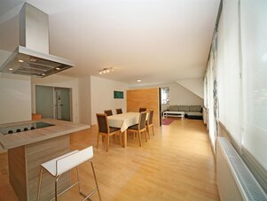 Open-plan kitchen with island, dining table, and living area