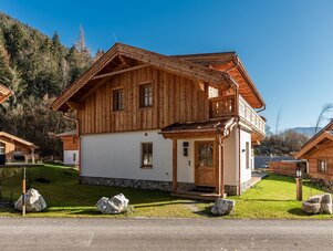 Traditional wooden chalet with white base in a mountain village