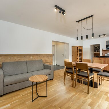 Open-plan living and dining area with wooden furniture.
