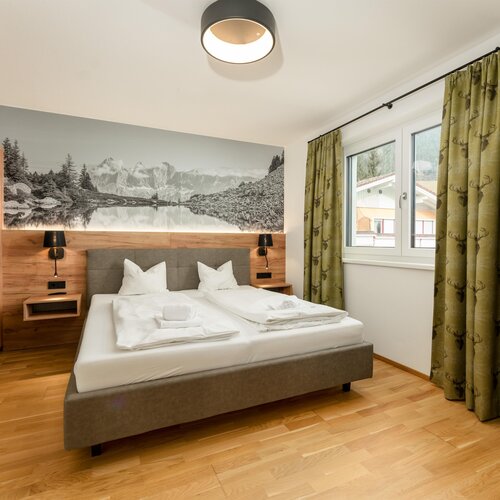 Hotel bedroom with double bed and wood accents