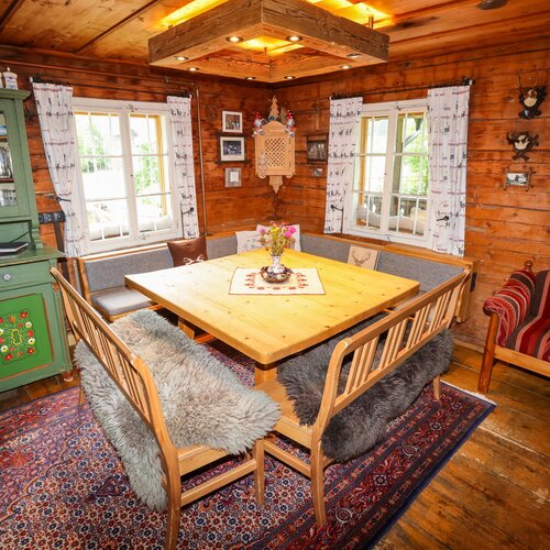 Cozy rustic cabin dining area with a wooden table and benches