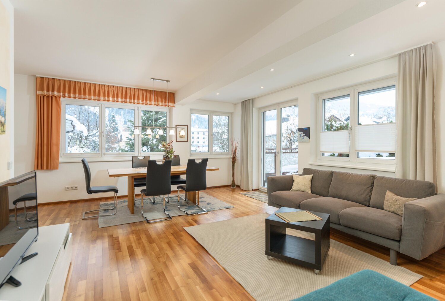 Bright open-plan living and dining room with large windows
