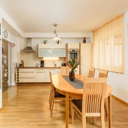Bright kitchen and dining area with wooden table and chairs