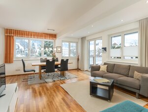 Bright open living and dining area with large windows