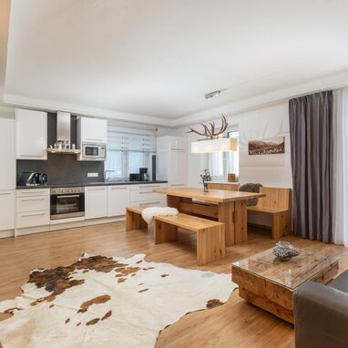 Open-plan kitchen and dining area with wooden furniture