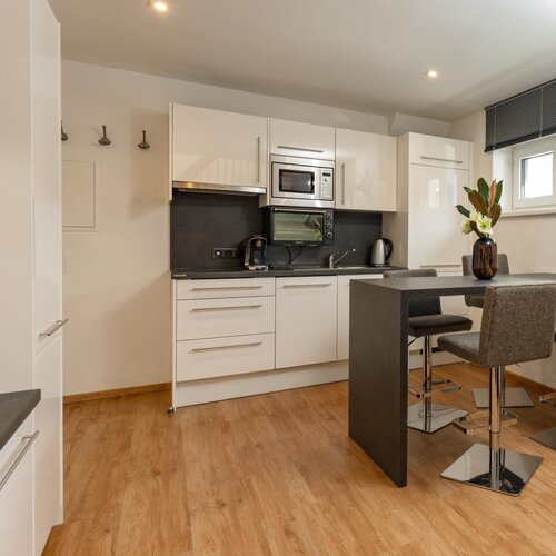 Modern white kitchen with island and dining area