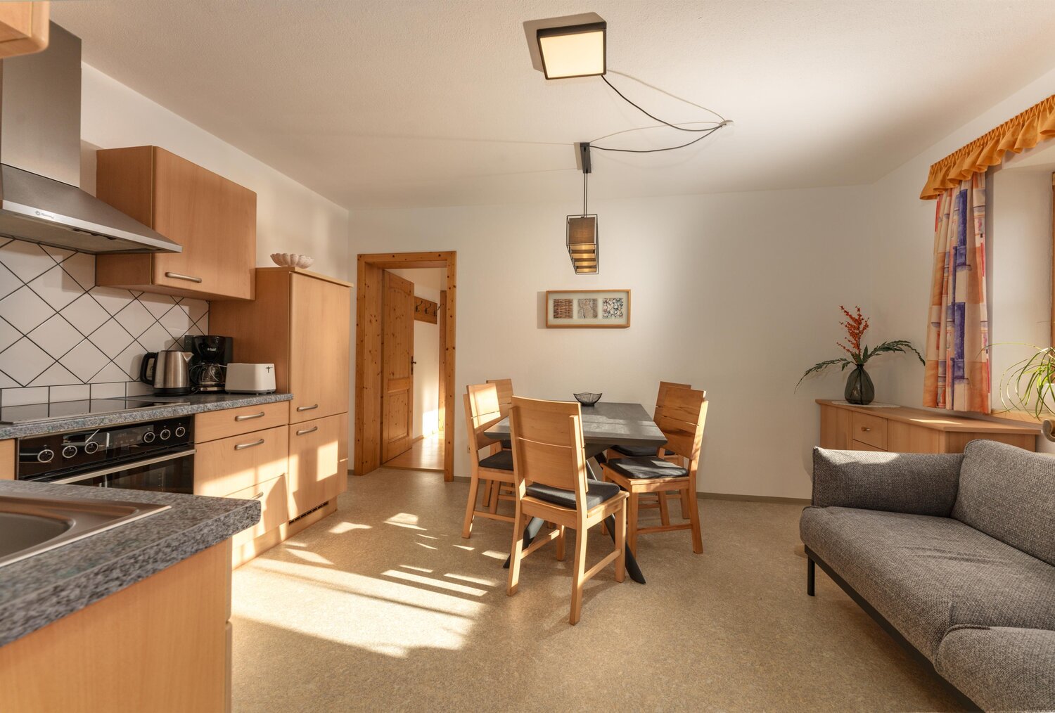 Bright kitchen and dining area with wooden cabinets and table