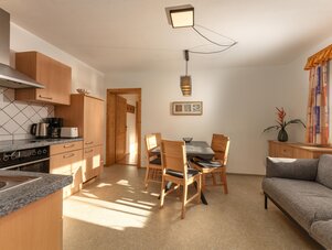 Open-plan kitchen and dining area with wooden cabinets