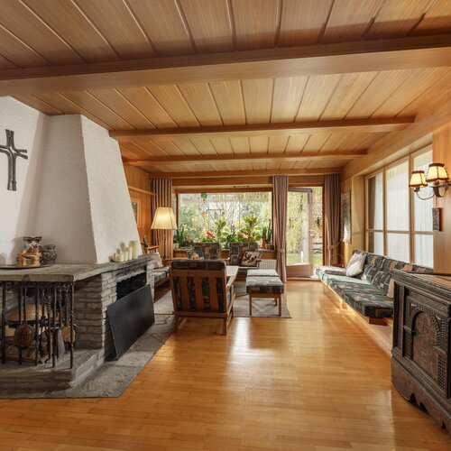 Cozy living room with stone fireplace and wooden ceiling