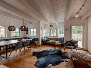 Bright open living room with dining table and benches