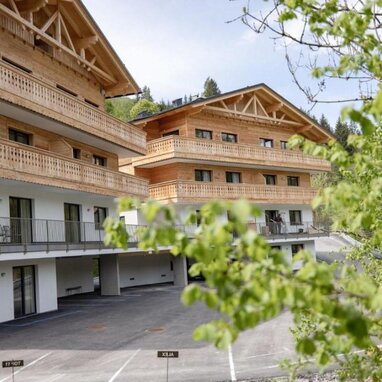 Alpine chalet-style wooden apartment building with multiple balconies