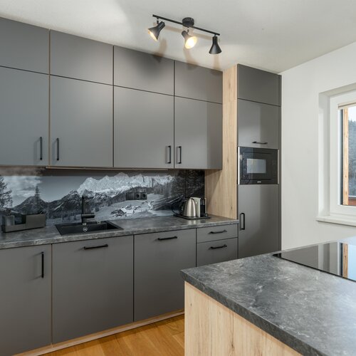 Modern gray kitchen with mountain backdrop
