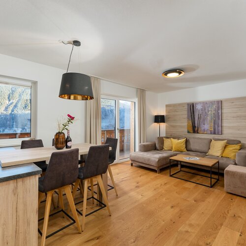 Bright open-plan living and dining area with mountain view