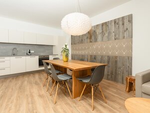 Bright kitchen and dining area with wooden table and chandelier