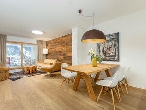 Bright open-plan living and dining room with wood accents