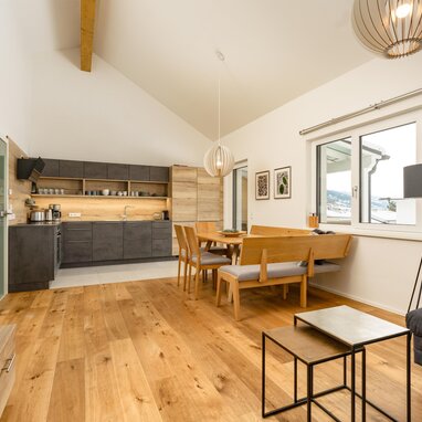 Open-plan kitchen and dining area with wooden furniture