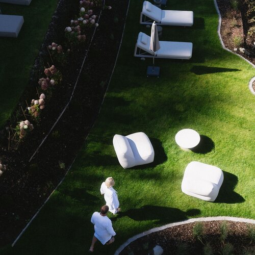 Aerial view of white lounge furniture on green lawn